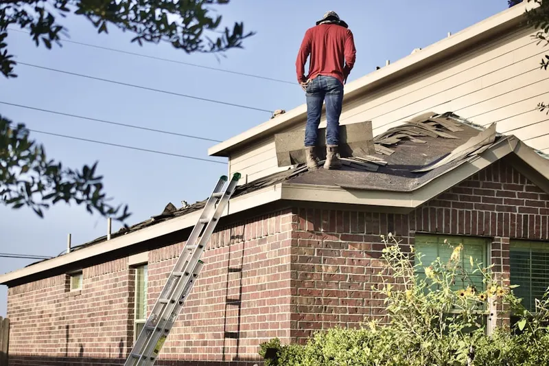 Professional roofer working on a residential roof in Hanover Hills